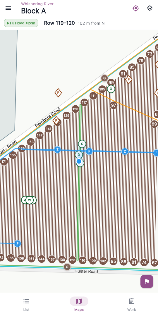 The field status bar — the GPS-quality badge (RTK Fixed ±2cm) on the left, then the row-lock icon, the row label (Row 12–13) and the distance from the near row end (135 m from S); the block name sits in the app bar above it.