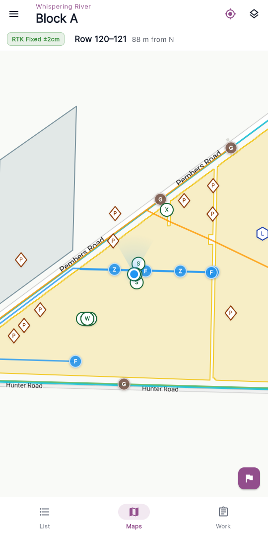 The Maps tab as it opens — GPS status bar across the top, vineyard blocks on the map, and the purple flag button floating in the bottom-right corner.